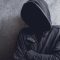man with face obscured by dark hoodie