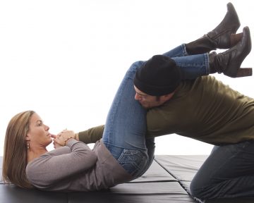 A woman trained in the martial arts using an armbar against a mugger